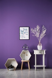 Photo of Composition with elegant vases near purple wall
