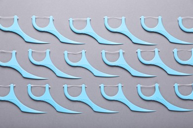 Photo of Flat lay composition with dental floss picks on grey background