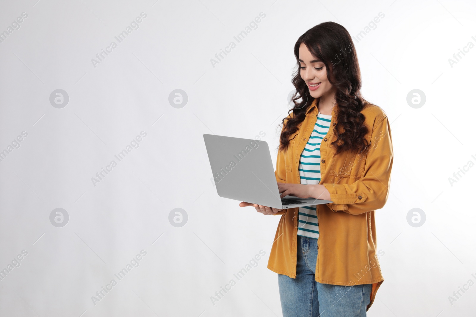 Photo of Young woman with laptop on white background