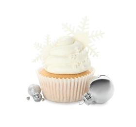 Photo of Tasty cupcake with snowflakes and Christmas baubles on white background