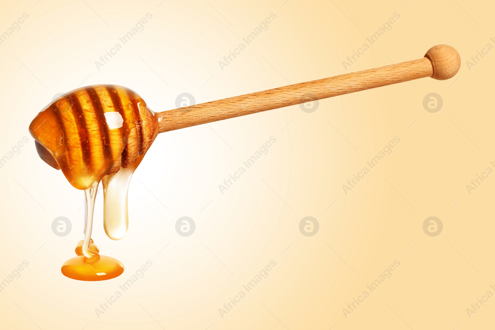 Image of Natural honey dripping from dipper on beige background