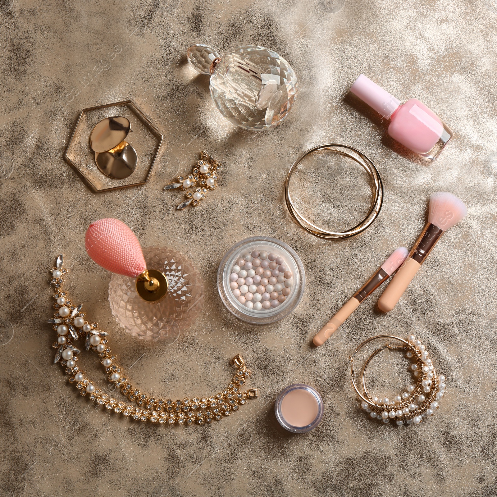 Photo of Composition with perfume bottles, cosmetics and jewellery on fabric, flat lay