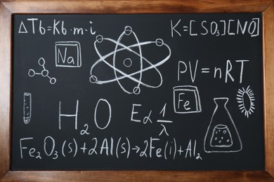 Photo of Different chemical formulas written with chalk on blackboard