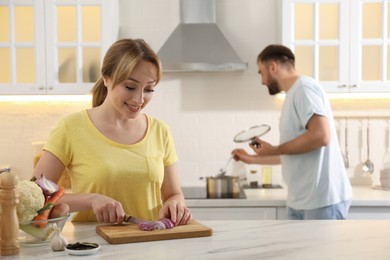 Young couple making bouillon in kitchen. Homemade recipe