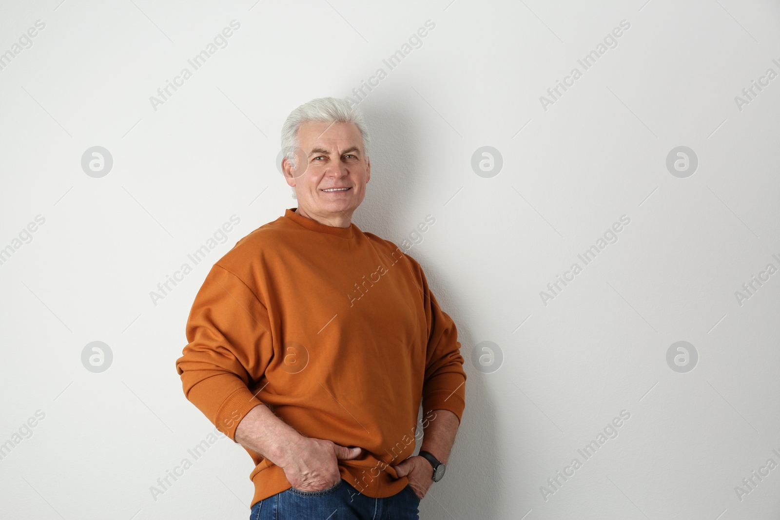 Photo of Portrait of handsome mature man on light background. Space for text