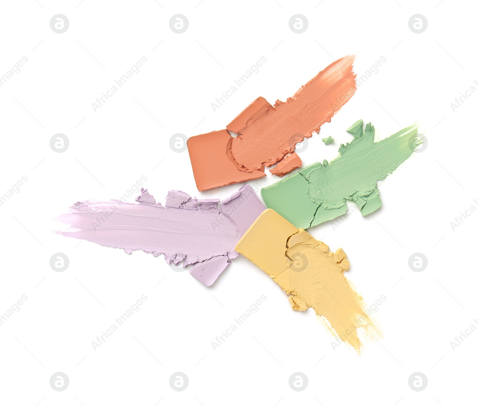 Photo of Samples of different color correcting concealers on white background, top view