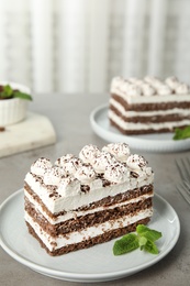 Photo of Plate of tiramisu cake on grey table, space for text