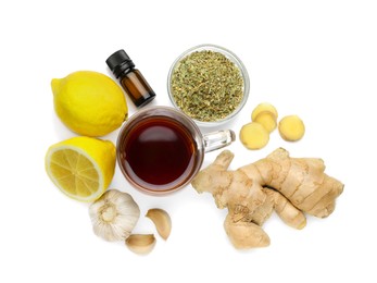 Cup of tea and different natural cold remedies on white background, top view. Cough treatment