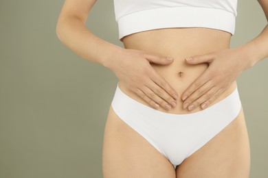 Photo of Gynecology. Woman in underwear on grey background, closeup