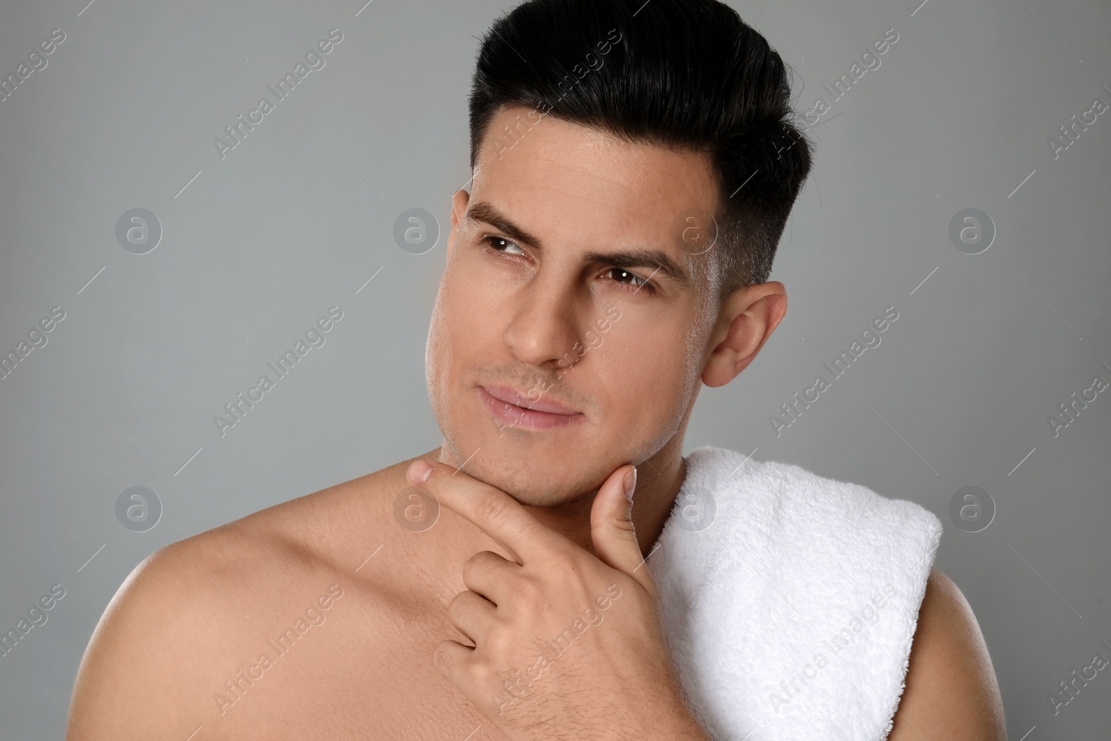 Photo of Handsome man after shaving on grey background