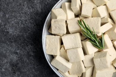 Delicious tofu with rosemary on grey table, top view