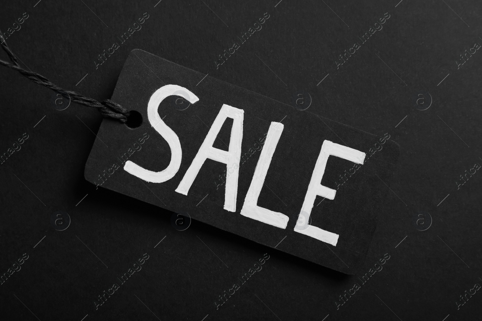 Photo of Sale Tag on color background, top view. Black Friday