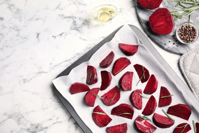 Photo of Flat lay composition with raw beetroot slices on white marble table