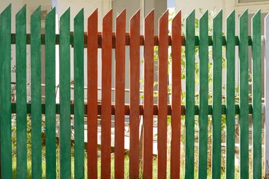 Wooden fence on sunny day outdoors, closeup