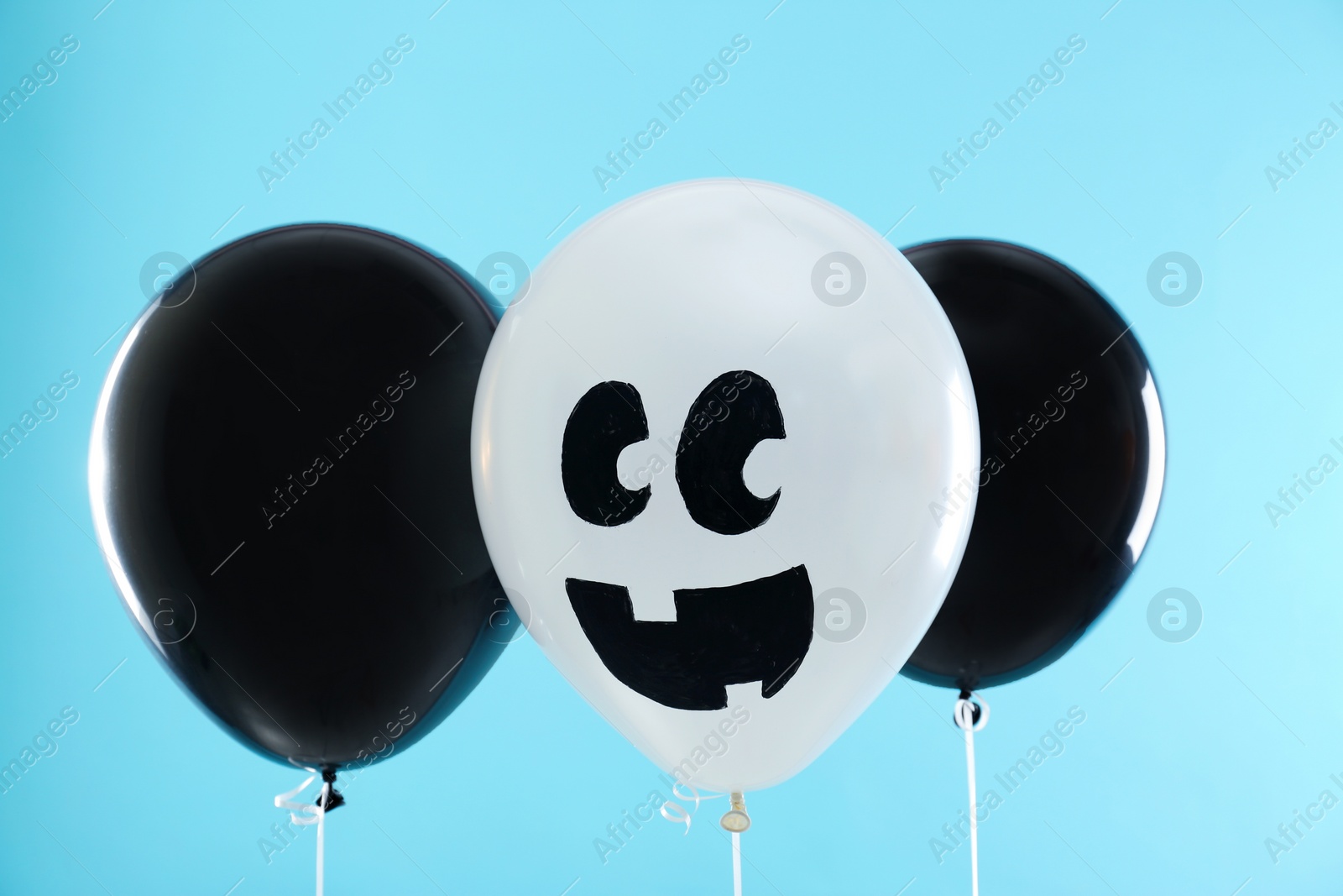 Photo of Colorful balloons for Halloween party on blue background