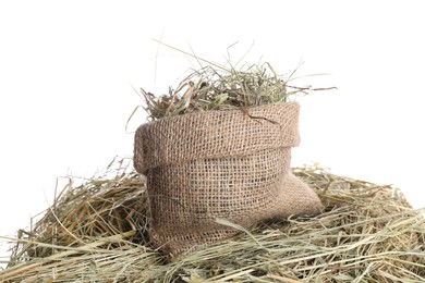 Dried hay and burlap sack isolated on white