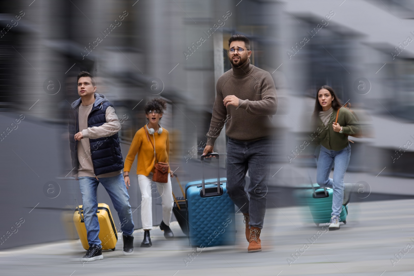 Image of Being late. Group of people with suitcases running outdoors. Motion blur effect