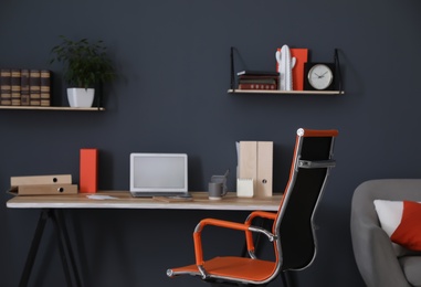 Photo of Modern workplace with comfortable chair in stylish home office interior