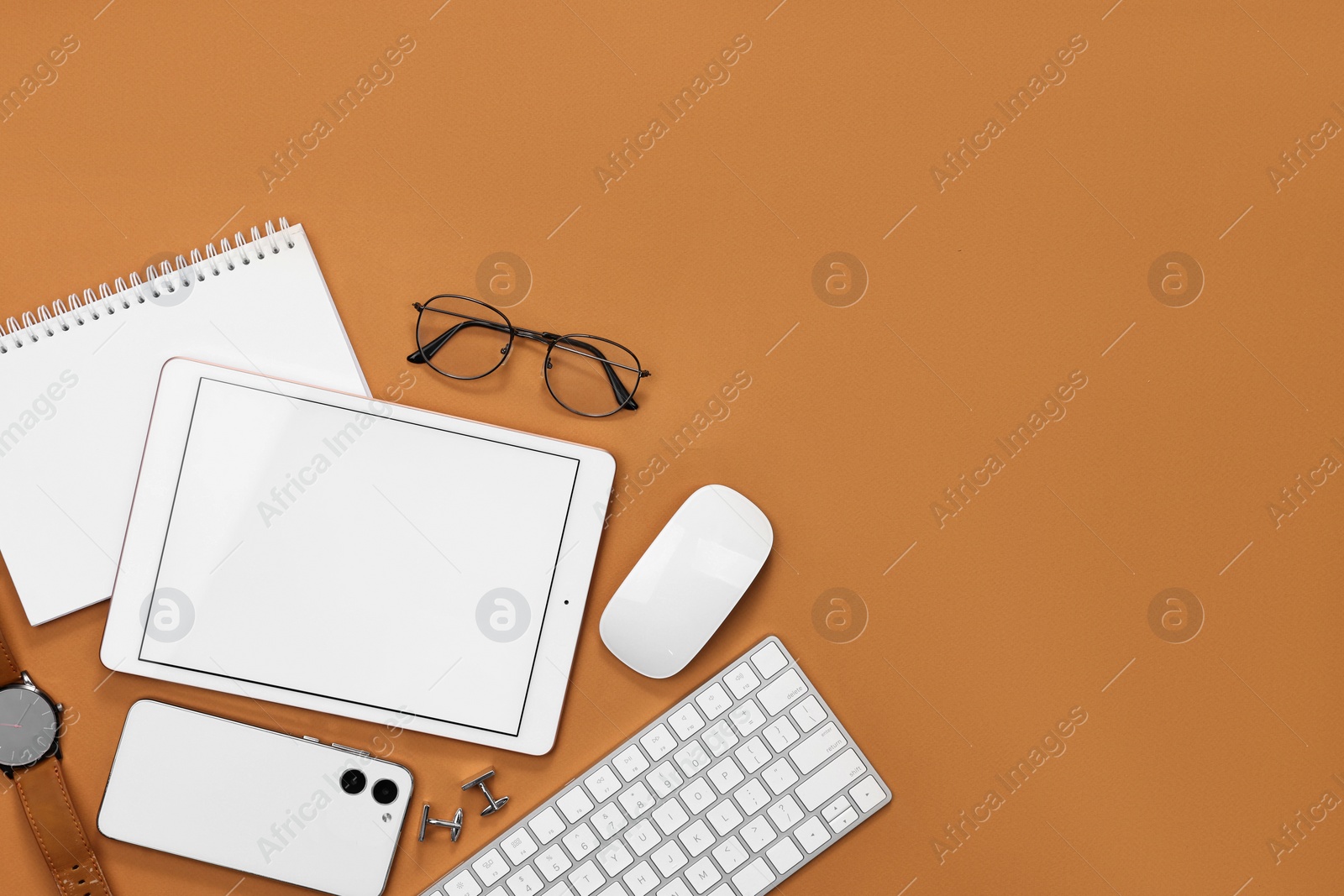 Photo of Flat lay composition with modern tablet on brown background. Space for text