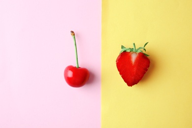 Photo of Flat lay composition with ripe red cherry and strawberry on color background