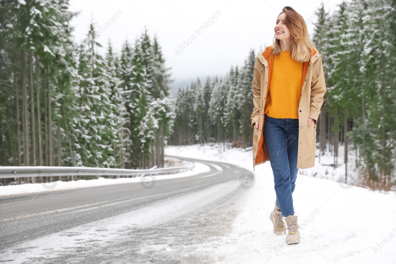 Photo of Young woman walking near snowy forest. Winter vacation