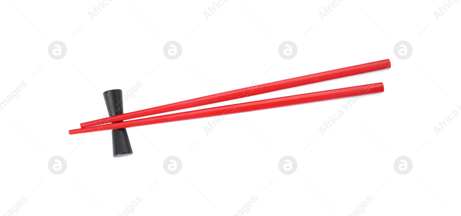 Photo of Pair of red chopsticks with rest isolated on white, top view