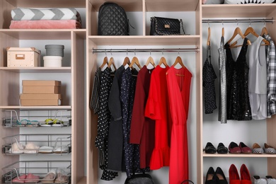 Photo of Large wardrobe with different clothes, home stuff and shoes