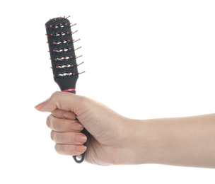 Photo of Woman holding vented hair brush on white background, closeup