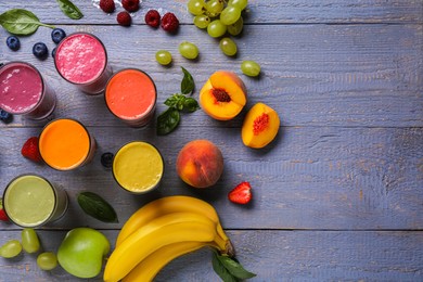 Photo of Many different delicious smoothies and ingredients on grey wooden table, flat lay. Space for text