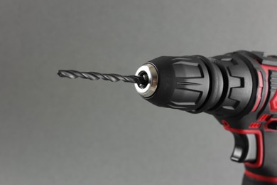 Modern electric screwdriver on grey background, closeup