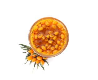 Delicious sea buckthorn jam in bowl and fresh berries on white background, top view