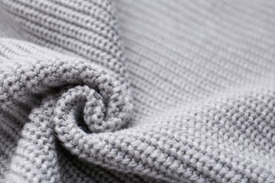 Grey knitted fabric as background, closeup view