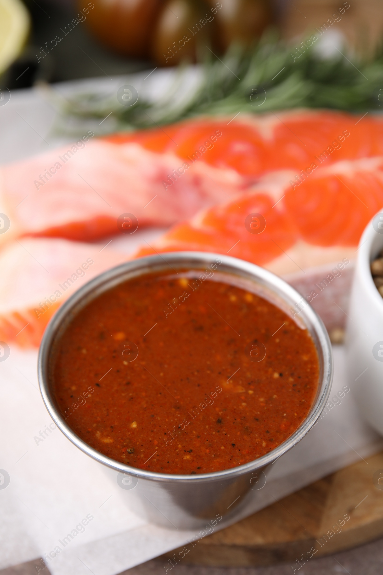 Photo of Tasty fish marinade in bowl on table, closeup