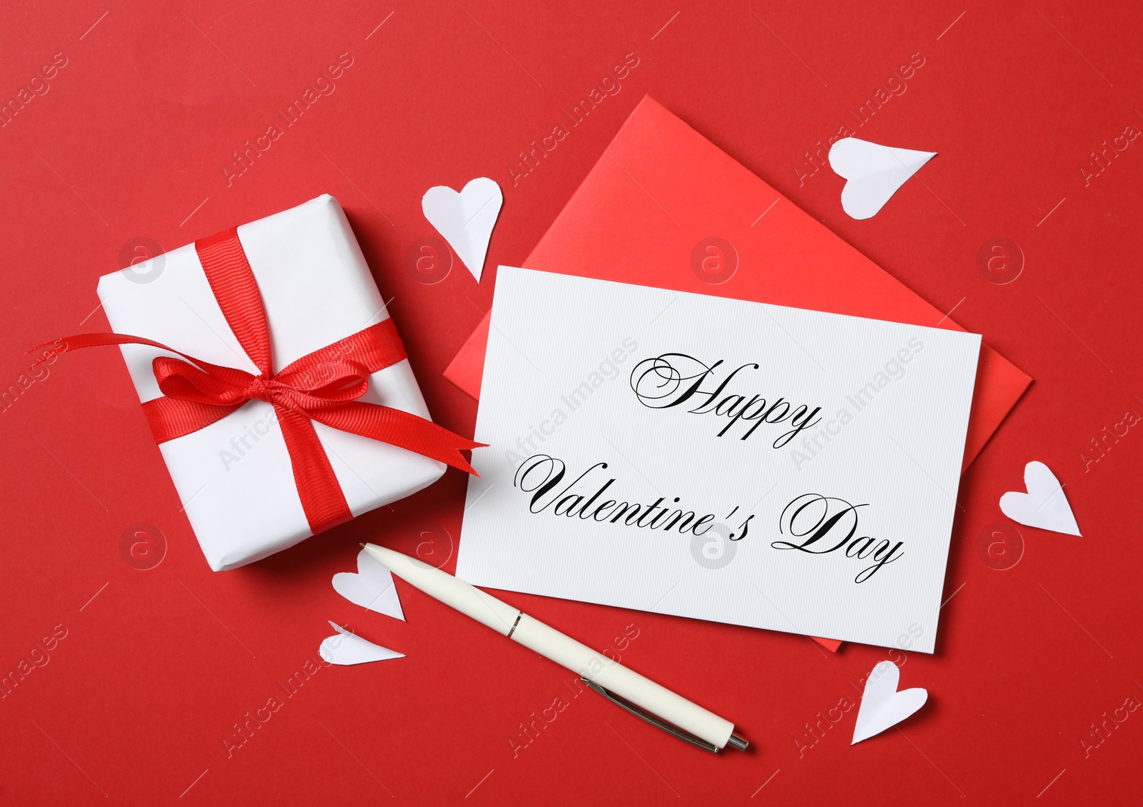 Image of Happy Valentine's Day. Flat lay composition with greeting card on red background 