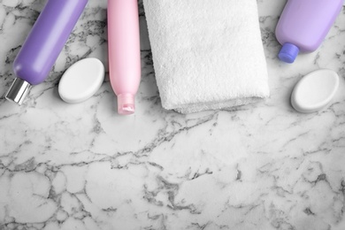 Flat lay composition with fresh towel on white marble table. Space for text