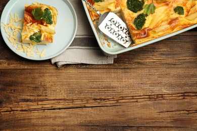 Photo of Tasty broccoli casserole served on wooden table, flat lay. Space for text
