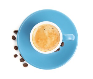 Cup of tasty espresso and scattered coffee beans on white background, top view