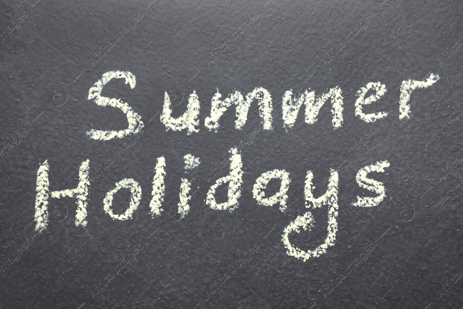 Photo of Phrase SUMMER HOLIDAYS written on black background. School's out