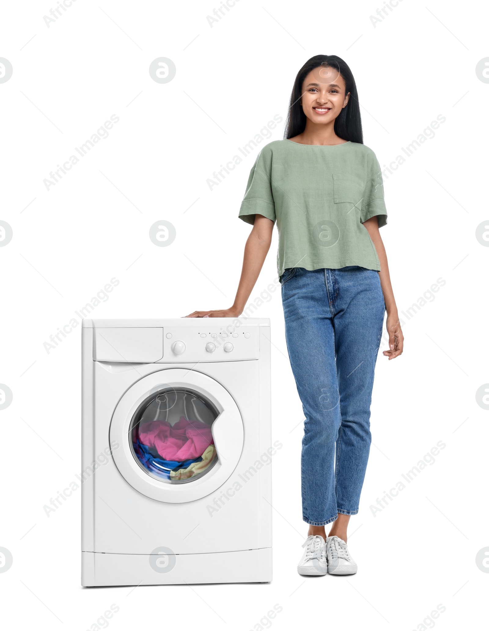 Photo of Beautiful woman near washing machine with laundry on white background