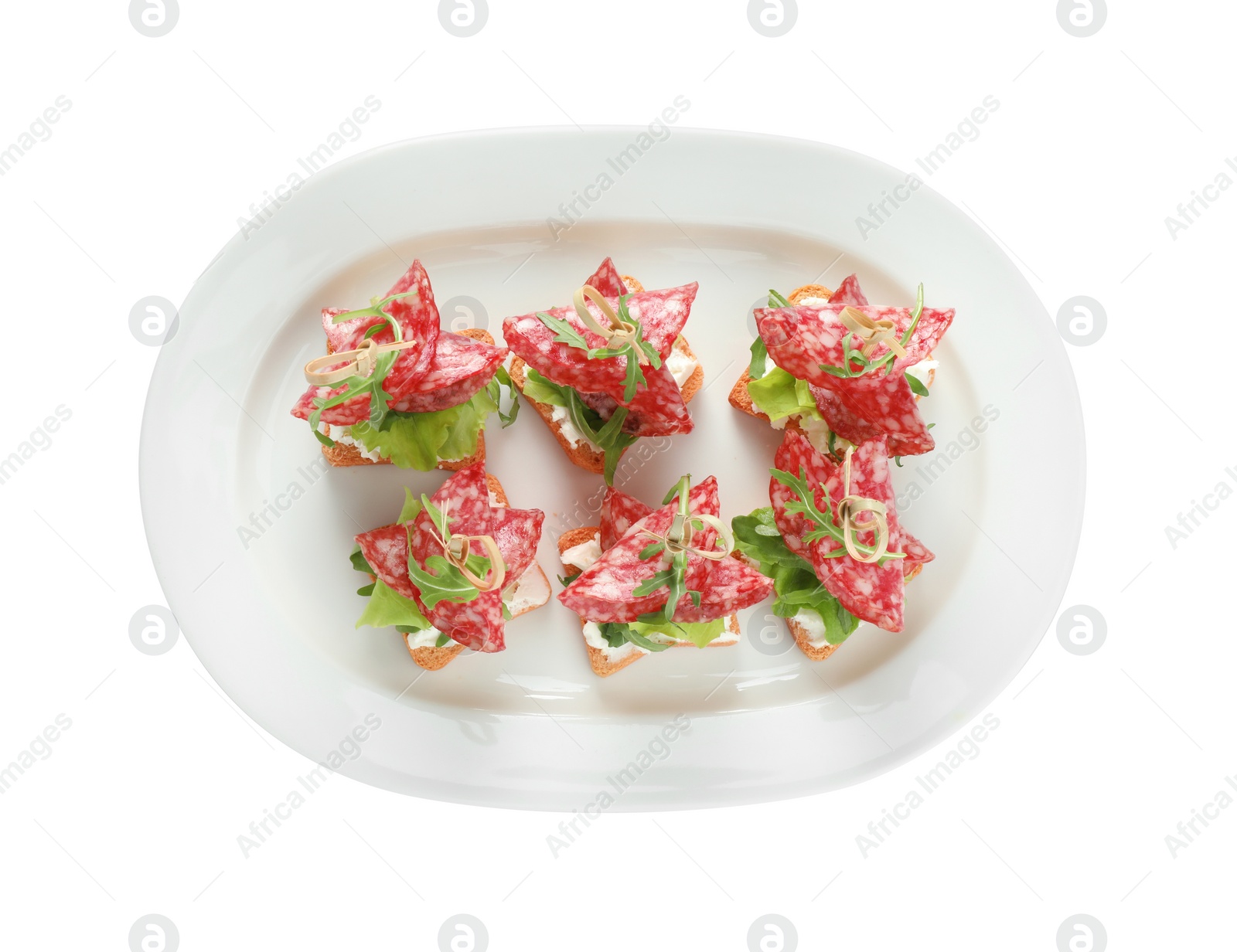 Photo of Tasty canapes with salami, greens and cream cheese isolated on white, top view