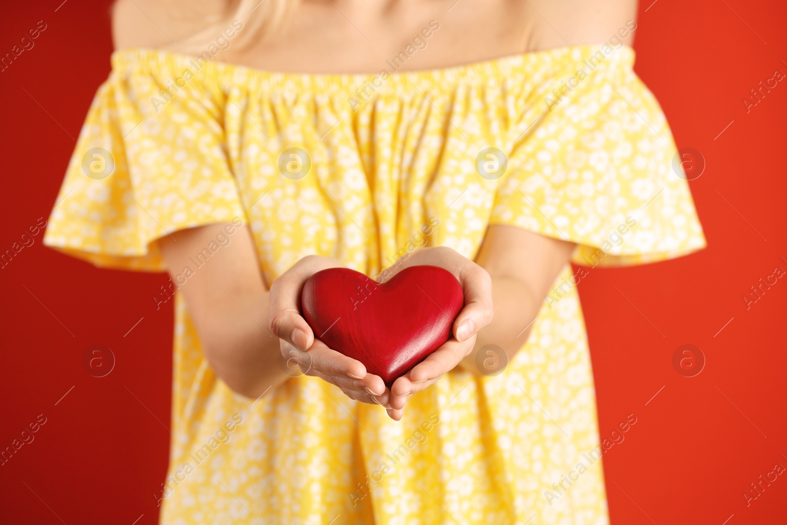 Photo of Woman with decorative heart on color background, closeup