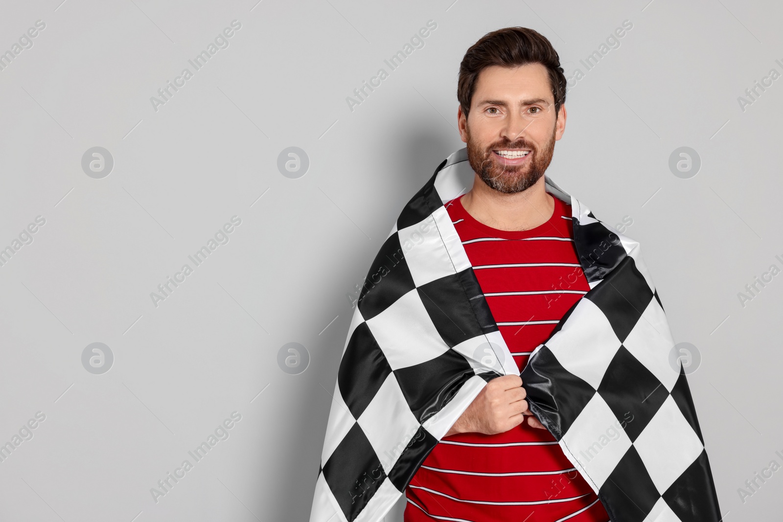 Photo of Man with checkered flag on white background, space for text