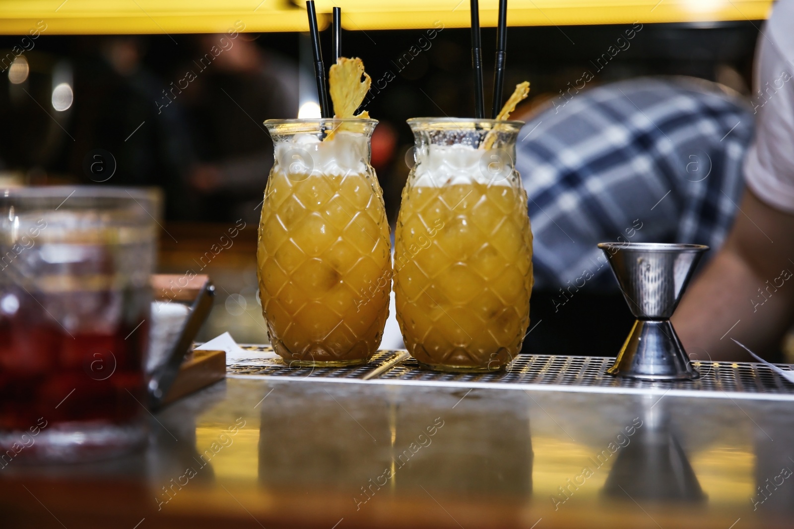 Photo of Glasses of tasty cocktail on bar counter