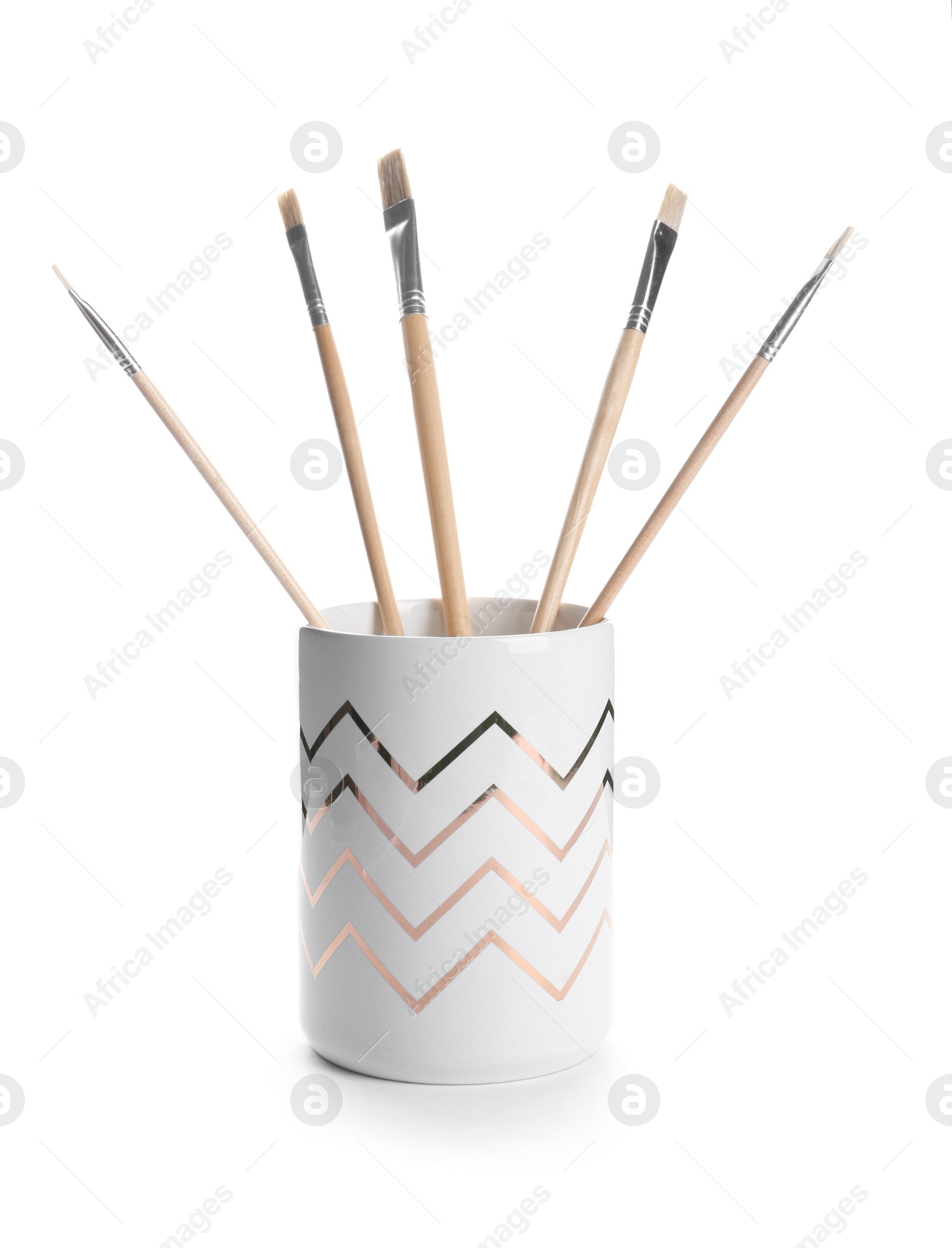 Photo of Holder with different paint brushes on white background