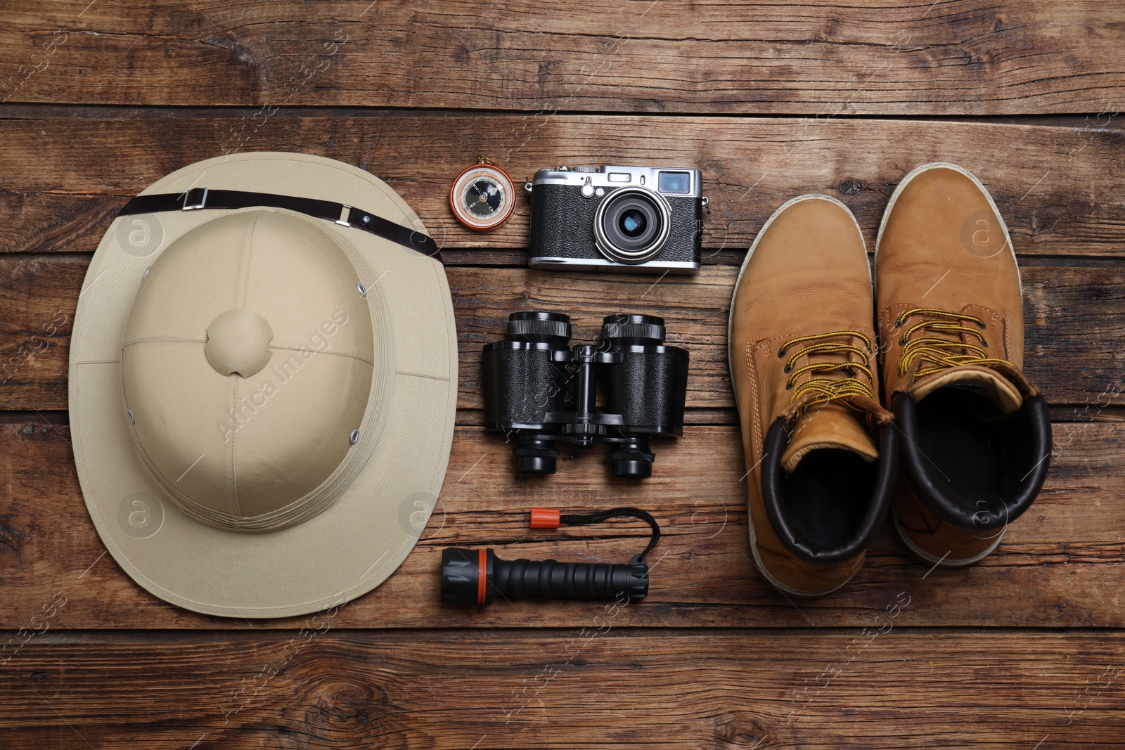 Photo of Flat lay composition with safari accessories on wooden background