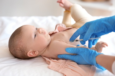 Doctor vaccinating baby in clinic