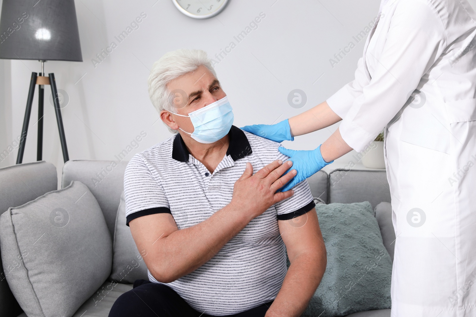 Photo of Doctor taking care of senior man with protective mask at nursing home