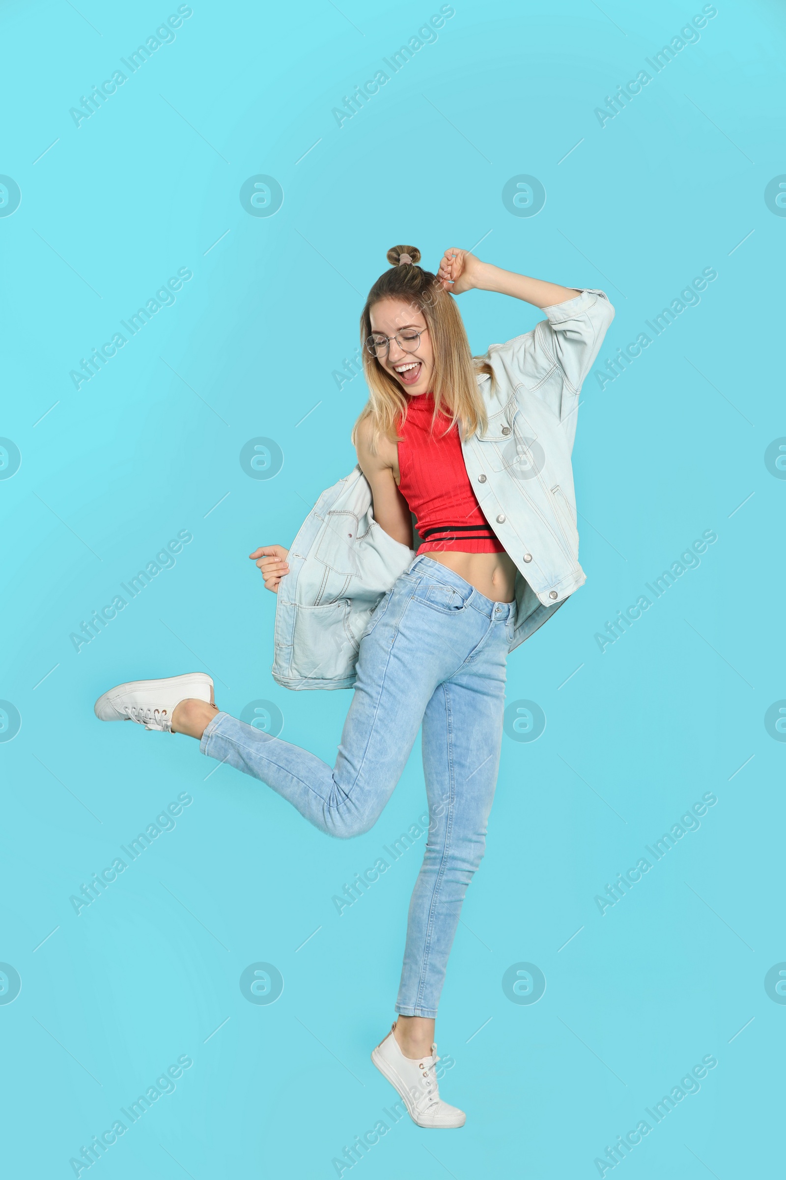 Photo of Full length portrait of emotional woman dancing on color background