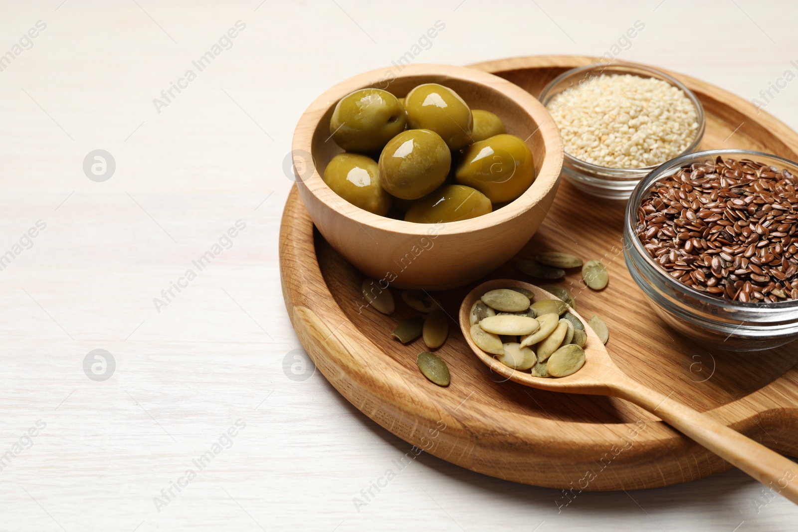 Photo of Different products high in vegetable fats on white wooden table, closeup. Space for text