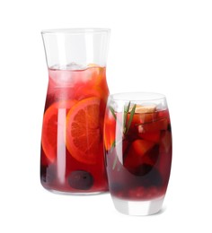 Jug and glass of delicious sangria isolated on white